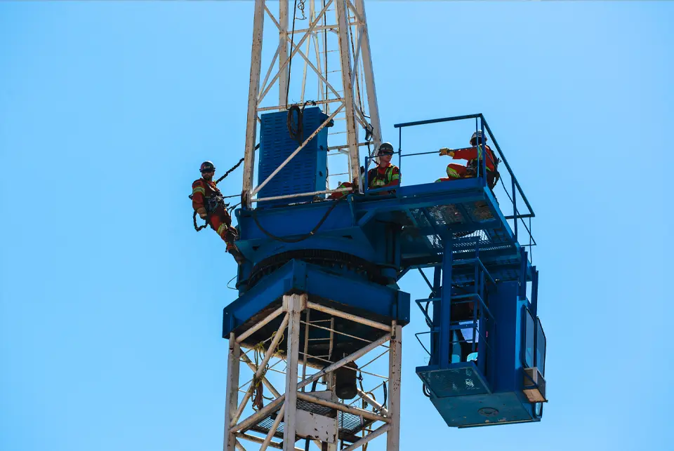 Atria construction crane with workers on site
