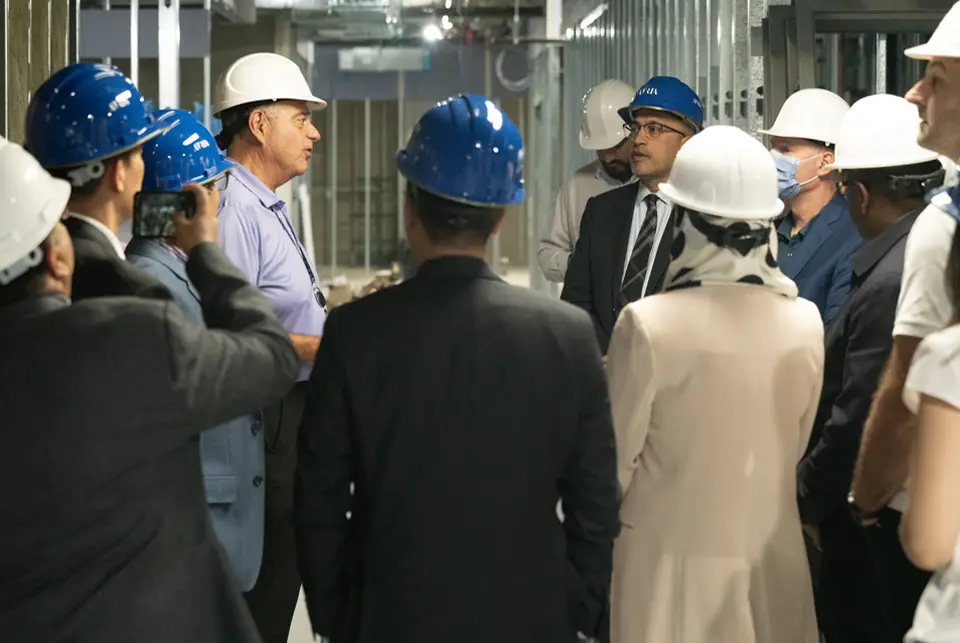 Atria project planning meeting with team members reviewing development blueprints