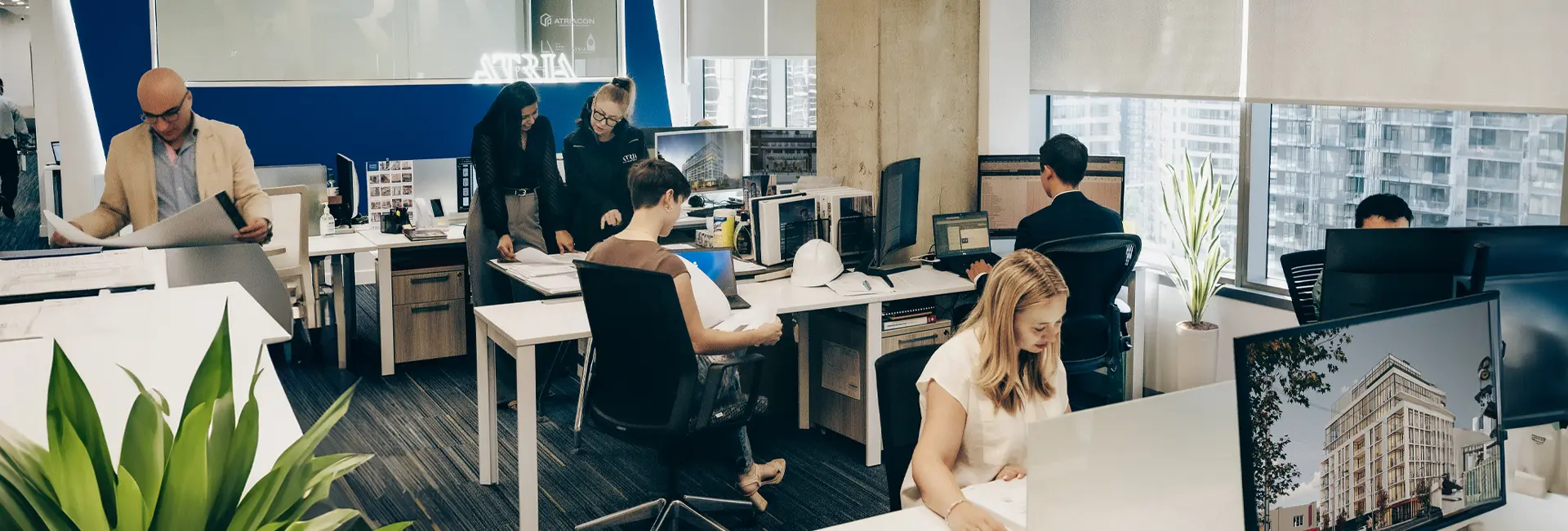 Team at Atria Development office collaborating on rental housing and property management projects in Toronto